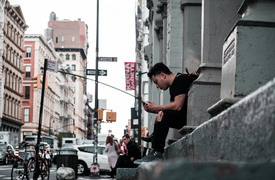 people using smartphones in city